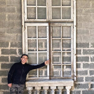 Cristiano next to the pieces of window and balustrades.
