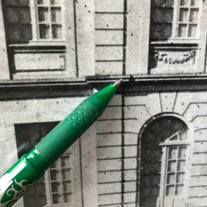 A pen pointing at the architrave of the Chateau on a photo.